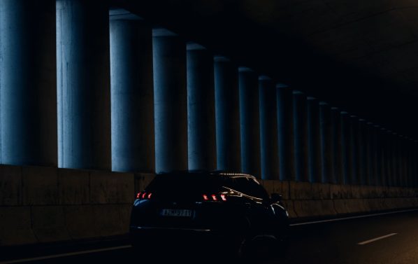 Car driving through a lit tunnel illustrating automotive applications of MagnetFab micromagnets and magnetic sensors